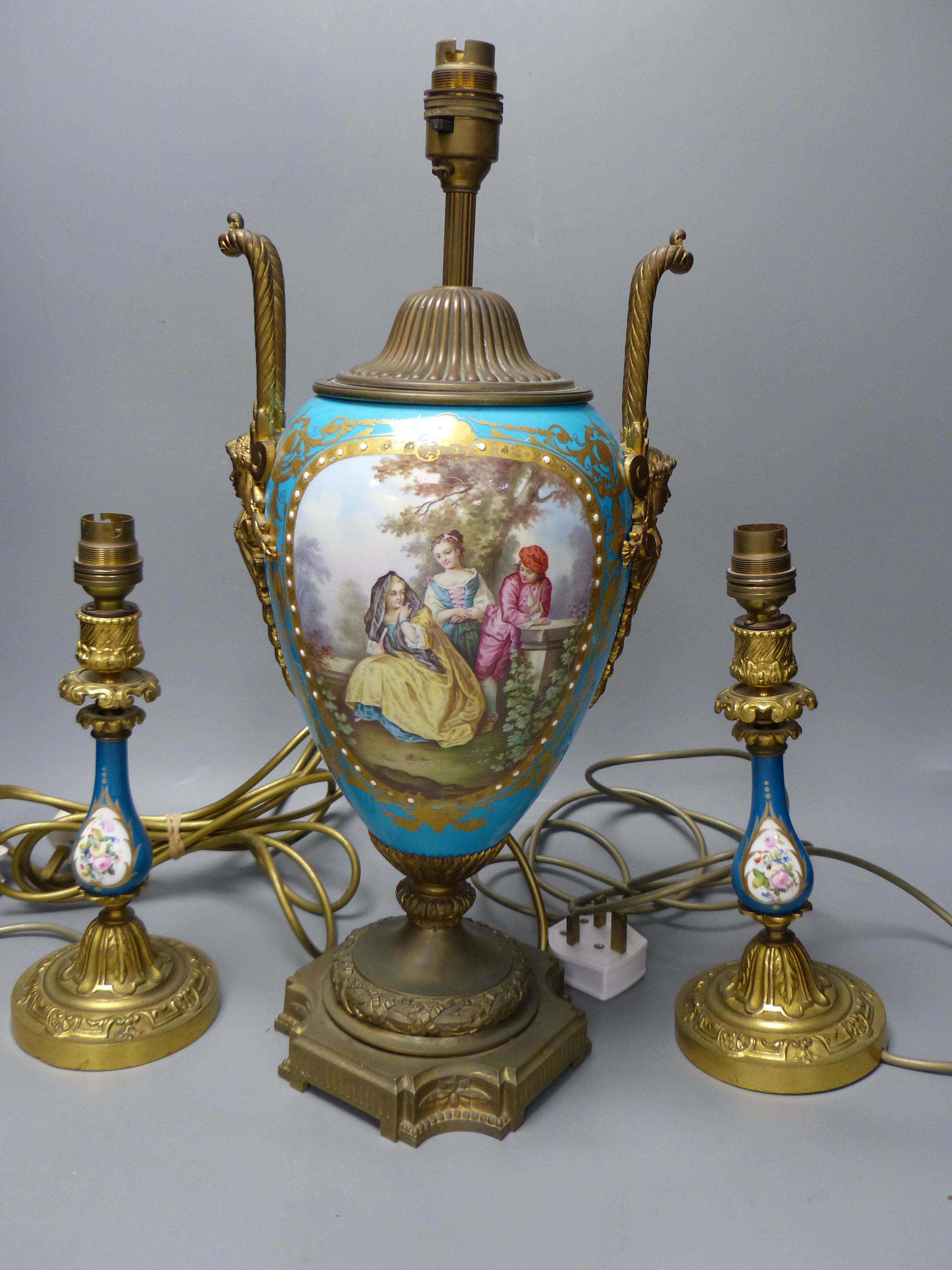 A pair of 19th century Sevres style porcelain and ormolu mounted lamps and a similar larger lamp